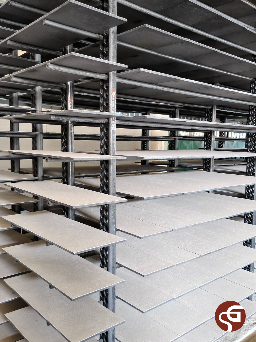 Structural framework of a kiln car featuring adjustable SiC support posts and shelves, set up for firing.